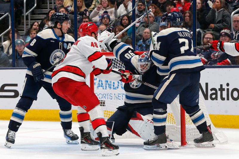 Dec 31, 2024; Columbus, Ohio, USA; Columbus Blue Jackets goalie Elvis Merzlikins (90) makes a save against the Carolina Hurricanes during the second period at Nationwide Arena. Mandatory Credit: Russell LaBounty-Imagn Images