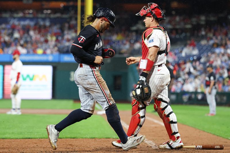 Sep 27, 2025; Philadelphia, Pennsylvania, USA; Minnesota Twins outfielder Austin Martin (16) scores a run in front of Philadelphia Phillies catcher J.T. Realmuto (10) during the seventh inning at Citizens Bank Park. Mandatory Credit: Bill Streicher-Imagn Images