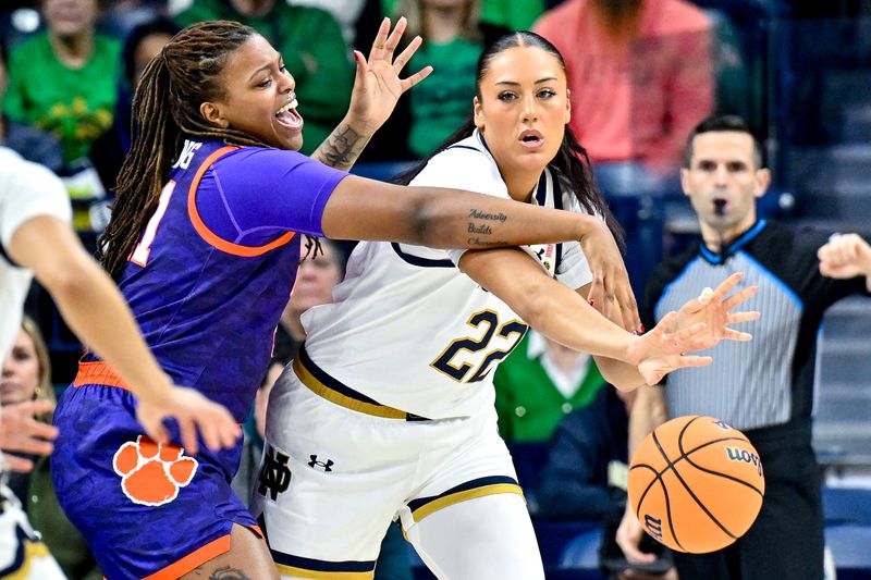 Feb 22, 2024; South Bend, Indiana, USA; Notre Dame Fighting Irish forward Nat Marshall (15) passes the ball as Clemson Tigers center Eno Inyang (21) defends in the first half at the Purcell Pavilion. Mandatory Credit: Matt Cashore-USA TODAY Sports