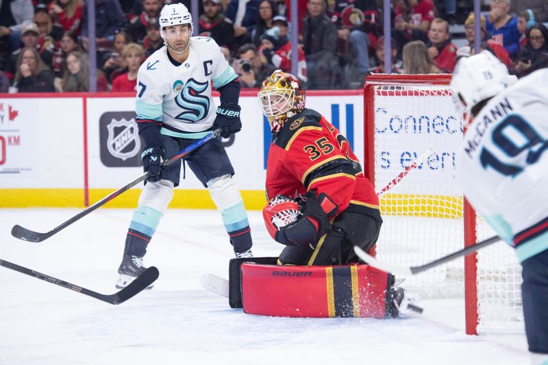 Oct 16, 2025; Ottawa, Ontario, CAN; Seattle Kraken left wing Jared McCann (19) shoots on Ottawa Senators goalie LIinus Ullmark (35) in the second period at the Canadian Tire Centre. Mandatory Credit: Marc DesRosiers-IMAGN Images