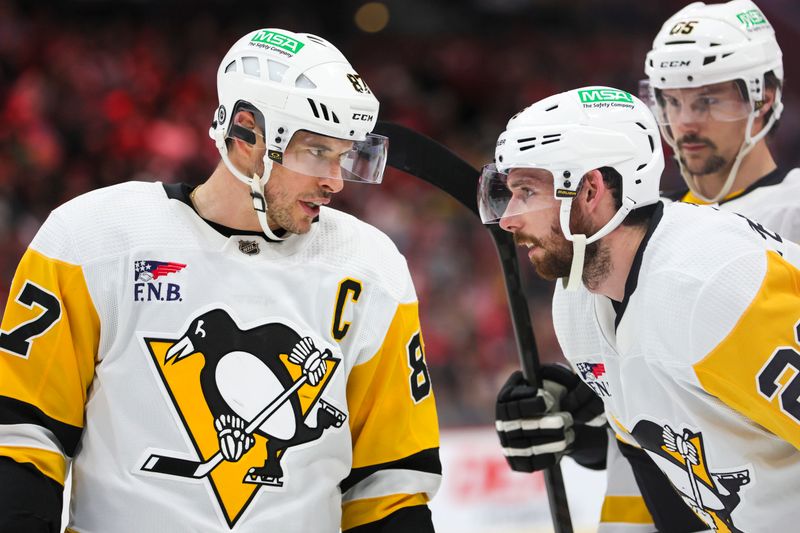 Dec 8, 2023; Sunrise, Florida, USA; Pittsburgh Penguins center Sidney Crosby (87) talks to defenseman Marcus Pettersson (28) against the Florida Panthers during the first period at Amerant Bank Arena. Mandatory Credit: Sam Navarro-USA TODAY Sports