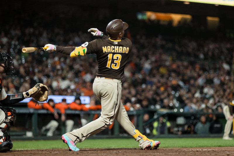 Sep 27, 2023; San Francisco, California, USA; San Diego Padres designated hitter Manny Machado (13) hits a two-run single against the San Francisco Giants during the tenth inning at Oracle Park. Mandatory Credit: John Hefti-USA TODAY Sports