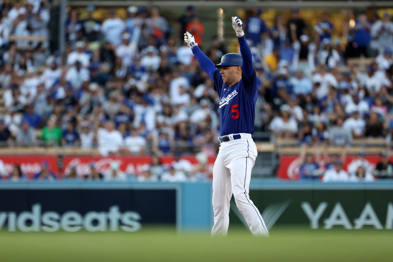 Aug 3, 2023; Los Angeles, California, USA;  Los Angeles Dodgers first baseman Freddie Freeman (5) celebrates on second base after a double during the first inning against the Oakland Athletics at Dodger Stadium. Mandatory Credit: Kiyoshi Mio-USA TODAY Sports