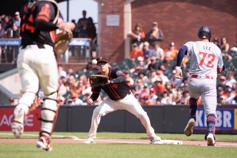 Jul 13, 2024; San Francisco, California, USA; San Francisco Giants catcher Patrick Bailey (14) throws to first baseman Wilmer Flores (41) for the force of Minnesota Twins third base Brooks Lee (72) during the first inning at Oracle Park. Mandatory Credit: Ed Szczepanski-USA TODAY Sports