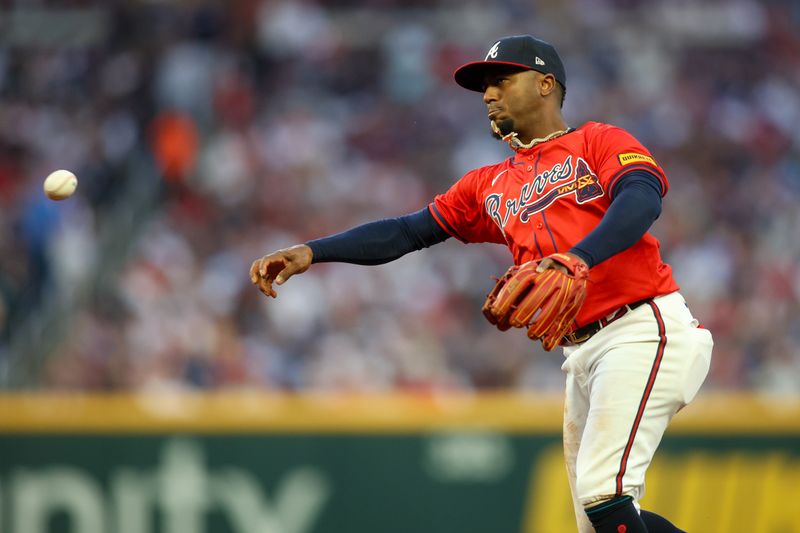 Apr 26, 2024; Atlanta, Georgia, USA; Atlanta Braves second baseman Ozzie Albies (1) throws a runner out at first against the Cleveland Guardians in the second inning at Truist Park. Mandatory Credit: Brett Davis-USA TODAY Sports