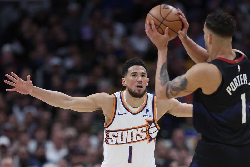 DENVER, COLORADO - MARCH 27: Devin Booker #1 of the Phoenix Suns guards Michael Porter Jr. #1 of the Denver Nuggets during the first quarter at Ball Arena on March 27, 2024 in Denver, Colorado. NOTE TO USER: User expressly acknowledges and agrees that, by downloading and or using this photograph, User is consenting to the terms and conditions of the Getty Images License Agreement.  (Photo by Matthew Stockman/Getty Images)