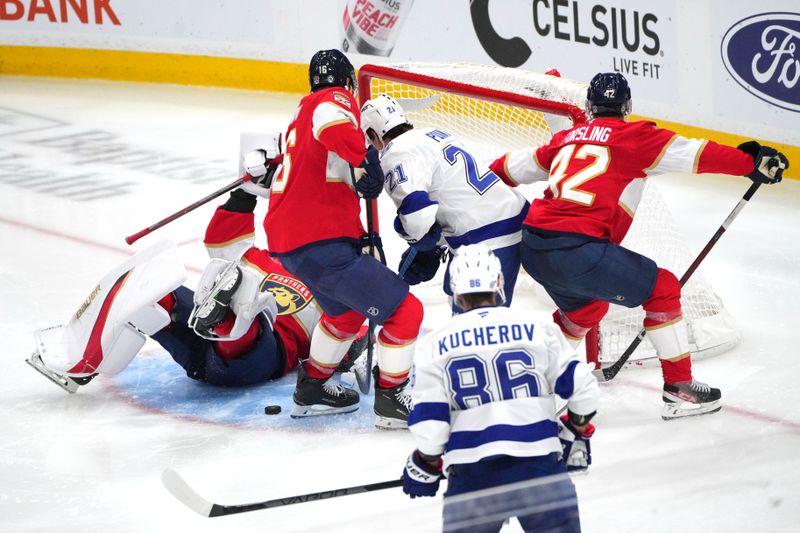 Sep 30, 2024; Sunrise, Florida, USA; Florida Panthers goaltender Spencer Knight (30) falls down as Tampa Bay Lightning center Brayden Point (21) closes in during the third period at Amerant Bank Arena. Mandatory Credit: Jim Rassol-Imagn Images