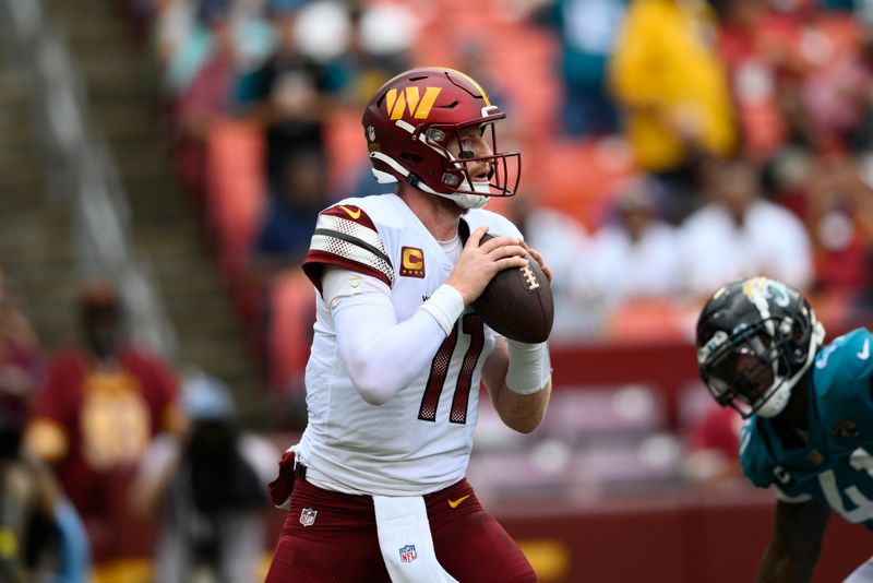 Washington Commanders quarterback Carson Wentz (11) in action during the second half of a NFL football game against the Jacksonville Jaguars, Sunday, Sept. 11, 2022, in Landover, Md. (AP Photo/Nick Wass)