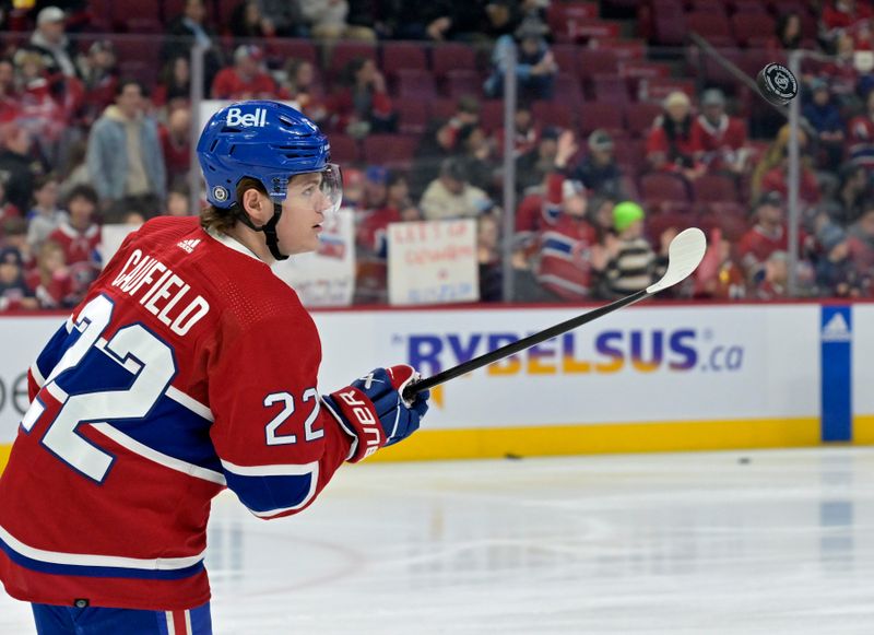 Feb 11, 2024; Montreal, Quebec, CAN; Montreal Canadiens forward Cole Caufield (22) juggles a puck during the warmup period before the game against the St.Louis Blues at the Bell Centre. Mandatory Credit: Eric Bolte-USA TODAY Sports