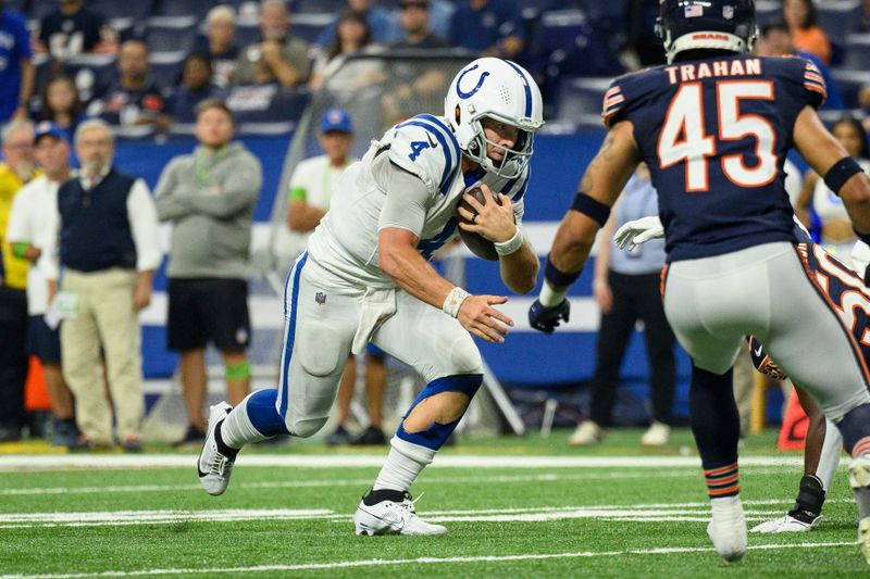 Indianapolis Colts quarterback Sam Ehlinger (4) runs up the middle during an NFL football game against the Chicago Bears, Saturday, Aug. 19, 2023, in Indianapolis. (AP Photo/Zach Bolinger)