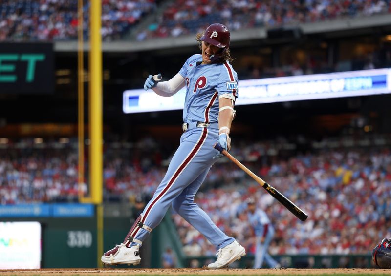 Aug 29, 2024; Philadelphia, Pennsylvania, USA; Philadelphia Phillies third base Alec Bohm (28) is injured while swinging for a pitch during the first inning against the Atlanta Braves at Citizens Bank Park. Mandatory Credit: Bill Streicher-USA TODAY Sports