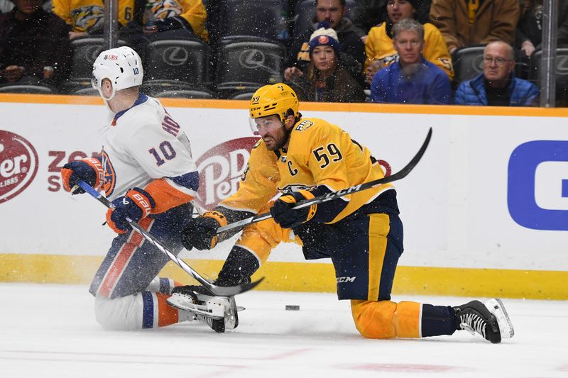 Jan 13, 2024; Nashville, Tennessee, USA; Nashville Predators defenseman Roman Josi (59) is taken down by New York Islanders right wing Simon Holmstrom (10) as he plays the puck during the second period at Bridgestone Arena. Mandatory Credit: Christopher Hanewinckel-USA TODAY Sports