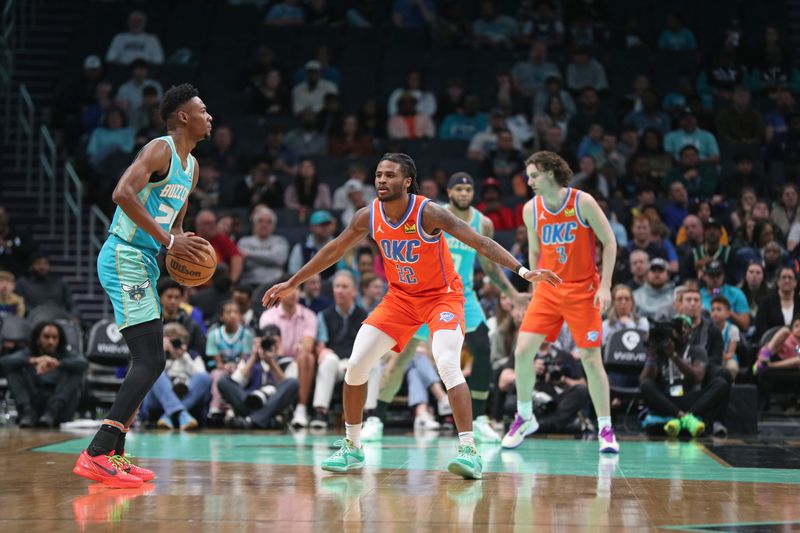 CHARLOTTE, NC - APRIL 7: Cason Wallace #22 of the Oklahoma City Thunder  plays defense against Brandon Miller #24 of the Charlotte Hornets during the game on April 7, 2024 at Spectrum Center in Charlotte, North Carolina. NOTE TO USER: User expressly acknowledges and agrees that, by downloading and or using this photograph, User is consenting to the terms and conditions of the Getty Images License Agreement.  Mandatory Copyright Notice:  Copyright 2024 NBAE (Photo by Brock Williams-Smith/NBAE via Getty Images)