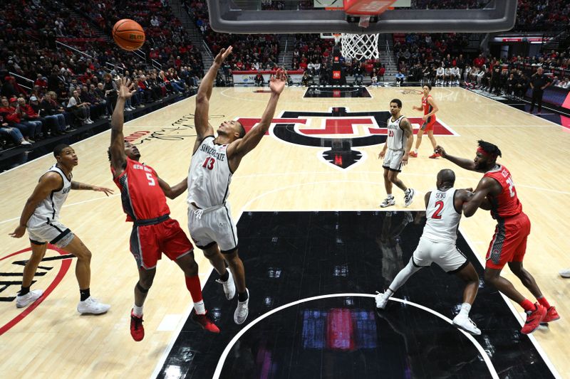 Jan 14, 2023; San Diego, California, USA; New Mexico Lobos guard Jamal Mashburn Jr. (5) shoots the ball over San Diego State Aztecs forward Jaedon LeDee (13) during the second half at Viejas Arena. Mandatory Credit: Orlando Ramirez-USA TODAY Sports