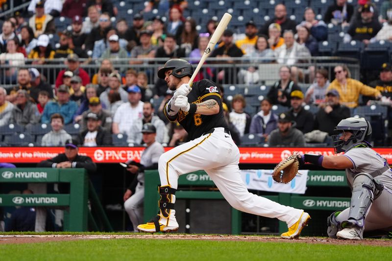 May 4, 2024; Pittsburgh, Pennsylvania, USA; Pittsburgh Pirates catcher Yasmani Grandal (6) hits a single against the Colorado Rockies during the second inning at PNC Park. Mandatory Credit: Gregory Fisher-USA TODAY Sports