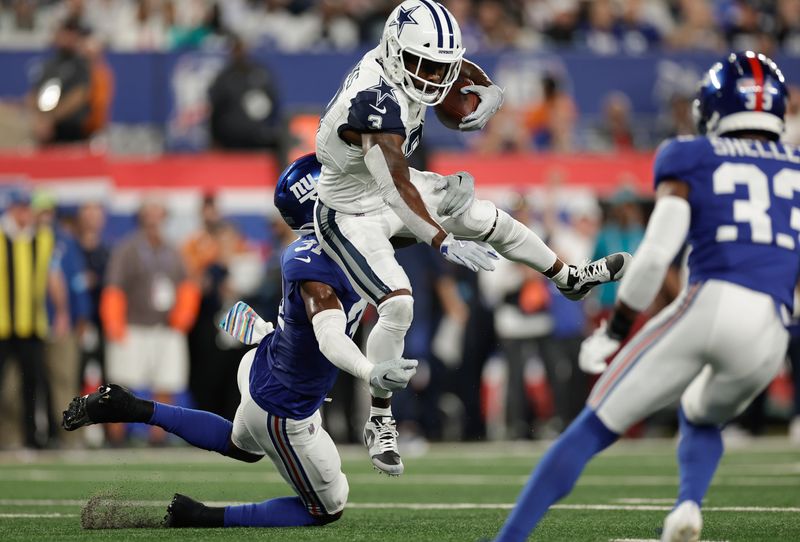 Dallas Cowboys wide receiver Brandin Cooks (3) tries to avoid a tackle from New York Giants safety Tyler Nubin (31) during the first quarter of an NFL football game, Thursday, Sept. 26, 2024, in East Rutherford, N.J. (AP Photo/Adam Hunger)