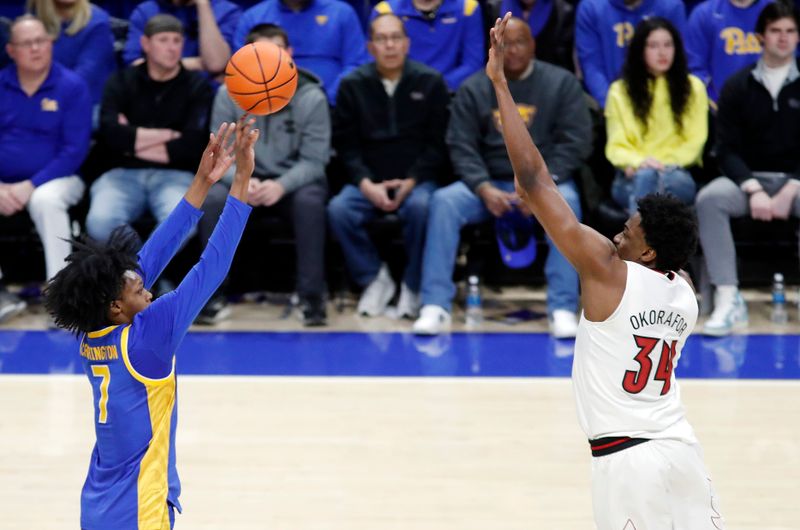 Feb 17, 2024; Pittsburgh, Pennsylvania, USA;  Pittsburgh Panthers guard Carlton Carrington (7) shoots against the Louisville Cardinals forward Emmanuel Okorafor (34) during the second half at the Petersen Events Center. Pittsburgh won 86-59. Mandatory Credit: Charles LeClaire-USA TODAY Sports