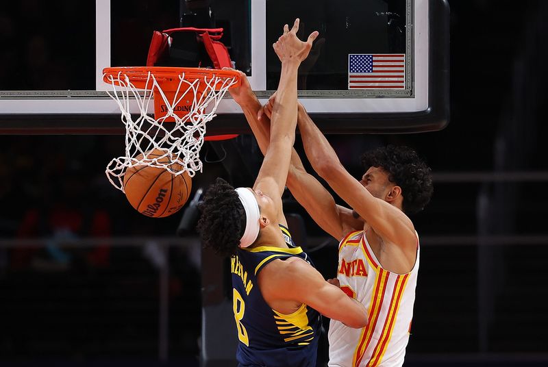 ATLANTA, GEORGIA - OCTOBER 08:  Zaccharie Risacher #10 of the Atlanta Hawks dunks against Enrique Freeman #8 of the Indiana Pacers during the third quarter at State Farm Arena on October 08, 2024 in Atlanta, Georgia.  NOTE TO USER: User expressly acknowledges and agrees that, by downloading and/or using this photograph, user is consenting to the terms and conditions of the Getty Images License Agreement.  (Photo by Kevin C. Cox/Getty Images)