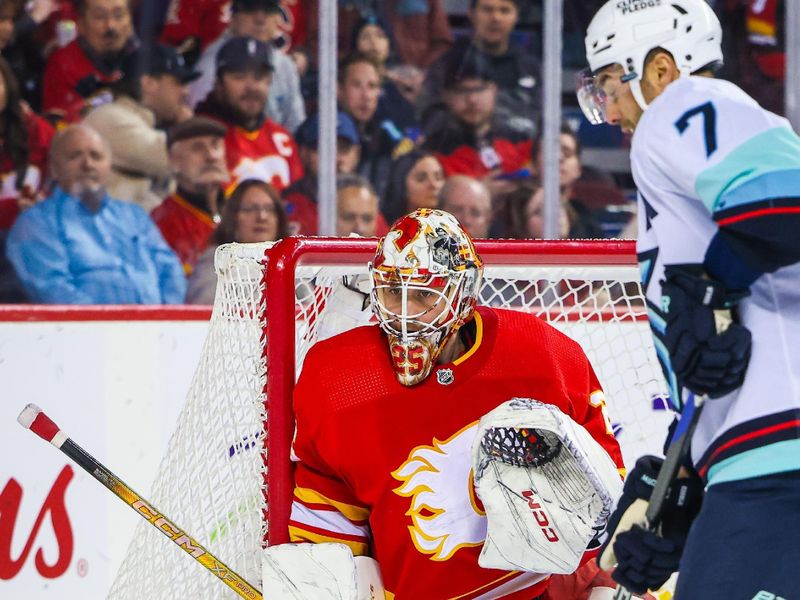 Dec 27, 2023; Calgary, Alberta, CAN; Calgary Flames goaltender Jacob Markstrom (25) guards his net against Seattle Kraken right wing Jordan Eberle (7) during the first period at Scotiabank Saddledome. Mandatory Credit: Sergei Belski-USA TODAY Sports