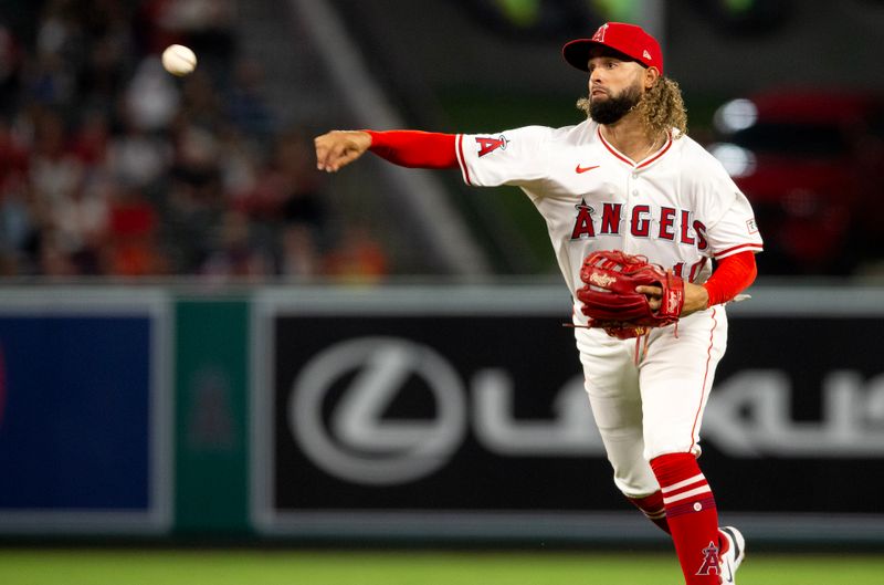 Sep 14, 2024; Anaheim, California, USA; Los Angeles Angels shortstop Jack Lopez (10) throws to first duirng the 3rd inning against the Houston Astros at Angel Stadium. Mandatory Credit: Jason Parkhurst-Imagn Images