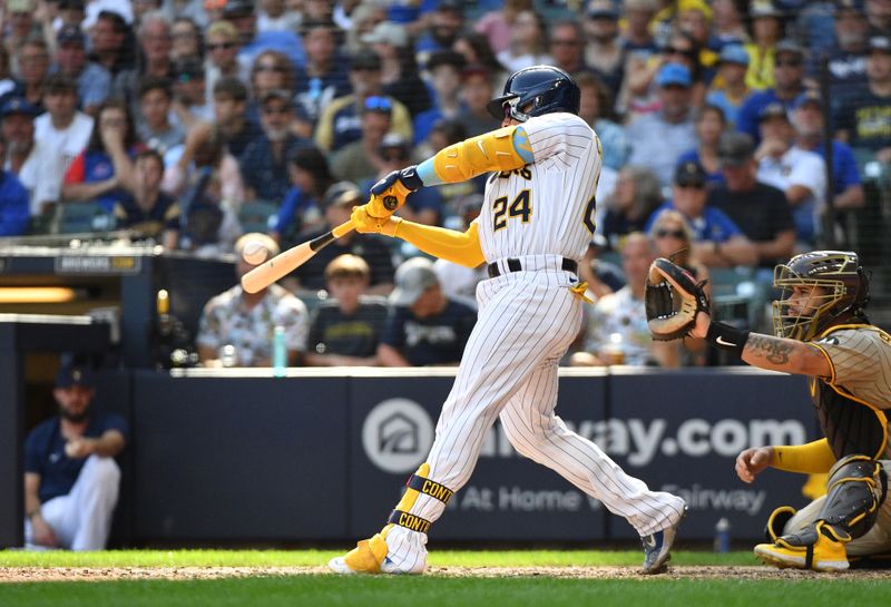 Aug 27, 2023; Milwaukee, Wisconsin, USA; Milwaukee Brewers catcher William Contreras (24) hits a double against the San Diego Padres in the seventh inning at American Family Field. Mandatory Credit: Michael McLoone-USA TODAY Sports