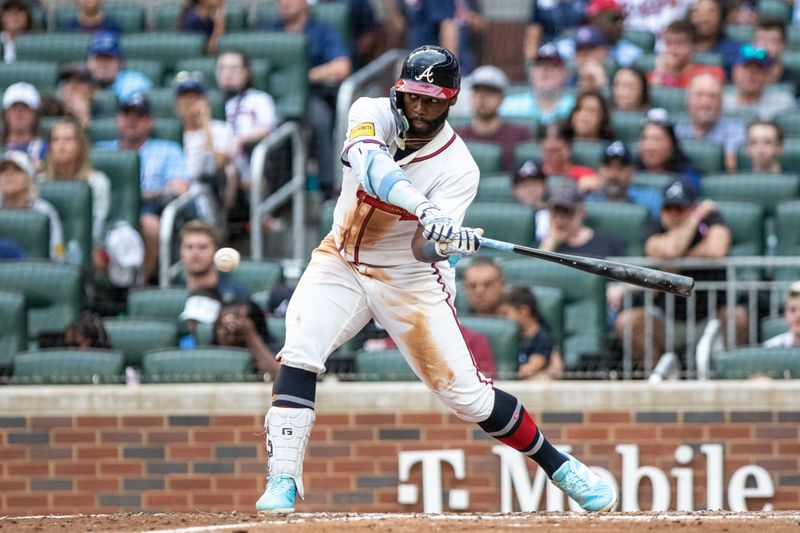 Sep 29, 2024; Cumberland, Georgia, USA; Atlanta Braves outfielder Michael Harris II (23) hits the ball into a fielders choice in the game against the Kansas City Royals during the ninth inning at Truist Park. Mandatory Credit: Jordan Godfree-Imagn Images