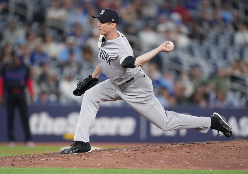 Jun 28, 2024; Toronto, Ontario, CAN; New York Yankees relief pitcher Tim Hill (54) throws a pitch against the Toronto Blue Jays during the ninth inning at Rogers Centre. Mandatory Credit: Nick Turchiaro-USA TODAY Sports