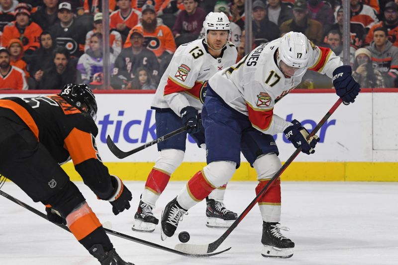 Jan 13, 2025; Philadelphia, Pennsylvania, USA; Florida Panthers center Evan Rodrigues (17) battles for the puck with Philadelphia Flyers defenseman Rasmus Ristolainen (55) during the second period at Wells Fargo Center. Mandatory Credit: Eric Hartline-Imagn Images