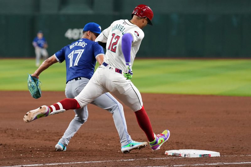 Jul 13, 2024; Phoenix, Arizona, USA; Arizona Diamondbacks outfielder Lourdes Gurriel Jr. (12) beats Toronto Blue Jays pitcher José Berríos (17) to first base for an infield RBI single during the fourth inning at Chase Field. Mandatory Credit: Joe Camporeale-USA TODAY Sports