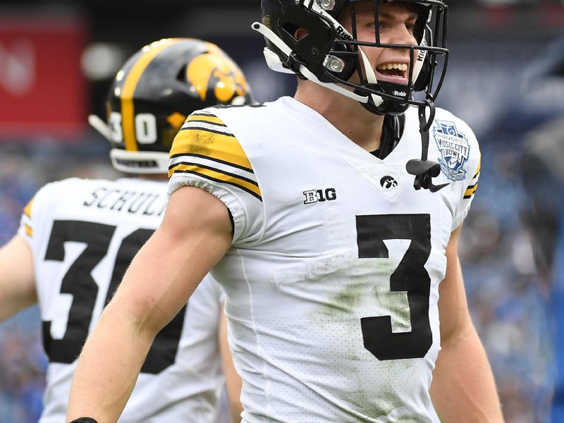 Dec 31, 2022; Nashville, Tennessee, USA; Iowa Hawkeyes defensive back Cooper DeJean (3) celebrates after returning an interception for a touchdown during the first half against the Kentucky Wildcats in the 2022 Music City Bowl at Nissan Stadium. Mandatory Credit: Christopher Hanewinckel-USA TODAY Sports