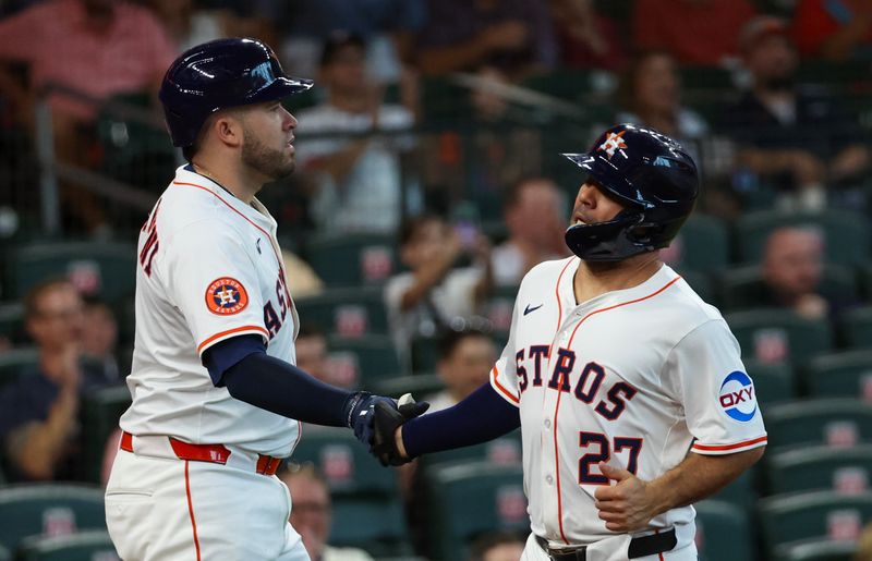 Jul 30, 2025; Houston, Texas, USA; Houston Astros first baseman Victor Caratini (17) celebrates  second baseman Jose Altuve (27) run against the Washington Nationals in the first inning at Daikin Park. Mandatory Credit: Thomas Shea-Imagn Images
