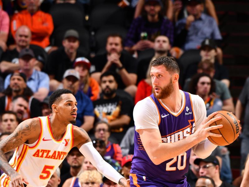 PHOENIX, AZ - MARCH 21:  Jusuf Nurkic #20 of the Phoenix Suns handles the ball during the game  on March 21, 2024 at Footprint Center in Phoenix, Arizona. NOTE TO USER: User expressly acknowledges and agrees that, by downloading and or using this photograph, user is consenting to the terms and conditions of the Getty Images License Agreement. Mandatory Copyright Notice: Copyright 2024 NBAE (Photo by Barry Gossage/NBAE via Getty Images)