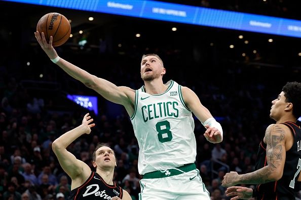 Boston, MA - December 28: Boston Celtics C Kristaps Porzingis shoots a lay-up in the second half. The Celtics beat the Detroit Pistons, 128-122, in overtime. (Photo by Danielle Parhizkaran/The Boston Globe via Getty Images)