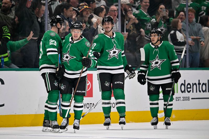 Oct 26, 2024; Dallas, Texas, USA; Dallas Stars defenseman Esa Lindell (23) and right wing Evgenii Dadonov (63) and left wing Mason Marchment (27) and center Logan Stankoven (11) celebrates a goal scored by Dadonov against the Chicago Blackhawks during the first period at the American Airlines Center. Mandatory Credit: Jerome Miron-Imagn Images