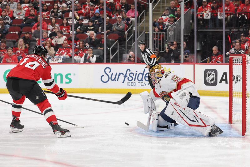 Oct 16, 2025; Newark, New Jersey, USA; Florida Panthers goaltender Daniil Tarasov (40) makes a save on New Jersey Devils center Luke Glendening (14) during the second period at Prudential Center. Mandatory Credit: Ed Mulholland-Imagn Images