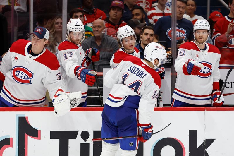 Oct 31, 2024; Washington, District of Columbia, USA; Montreal Canadiens center Nick Suzuki (14) celebrates with teammates after scoring a goal against the Washington Capitals in the second period at Capital One Arena. Mandatory Credit: Geoff Burke-Imagn Images