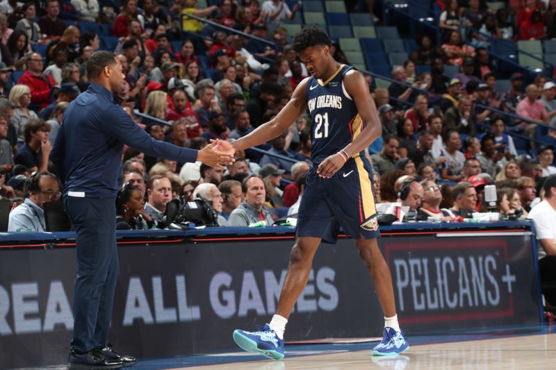 NEW ORLEANS, LA - NOVEMBER 6: Yves Missi #21 of the New Orleans Pelicans and Head Coach Willie Green of the New Orleans Pelicans high five during the game against the Cleveland Cavaliers on November 6, 2024 at the Smoothie King Center in New Orleans, Louisiana. NOTE TO USER: User expressly acknowledges and agrees that, by downloading and or using this Photograph, user is consenting to the terms and conditions of the Getty Images License Agreement. Mandatory Copyright Notice: Copyright 2024 NBAE (Photo by Layne Murdoch Jr./NBAE via Getty Images)