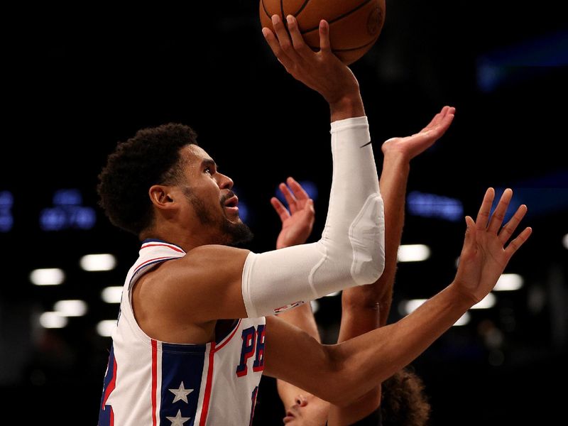 NEW YORK, NEW YORK - NOVEMBER 19:  Tobias Harris #12 of the Philadelphia 76ers takes a shot as Cameron Johnson #2 of the Brooklyn Nets defends in the second half at Barclays Center on November 19, 2023 in the Brooklyn borough of New York City. The Philadelphia 76ers defeated the Brooklyn Nets 121-99. NOTE TO USER: User expressly acknowledges and agrees that, by downloading and or using this photograph, User is consenting to the terms and conditions of the Getty Images License Agreement. (Photo by Elsa/Getty Images)