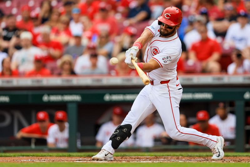 May 26, 2024; Cincinnati, Ohio, USA; Cincinnati Reds designated hitter Nick Martini (23) hits a single against the Los Angeles Dodgers in the second inning at Great American Ball Park. Mandatory Credit: Katie Stratman-USA TODAY Sports