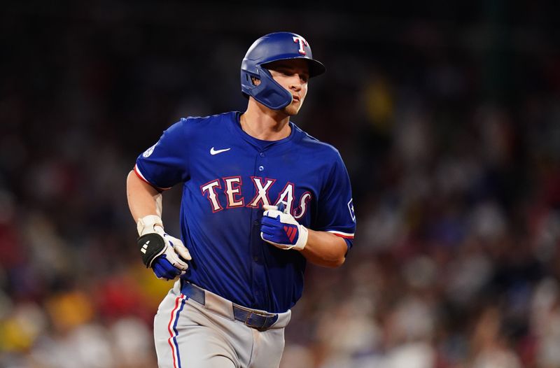 Aug 12, 2024; Boston, Massachusetts, USA; Texas Rangers shortstop Corey Seager (5) hits a two run home run against the Boston Red Sox in the seventh inning at Fenway Park. Mandatory Credit: David Butler II-USA TODAY Sports