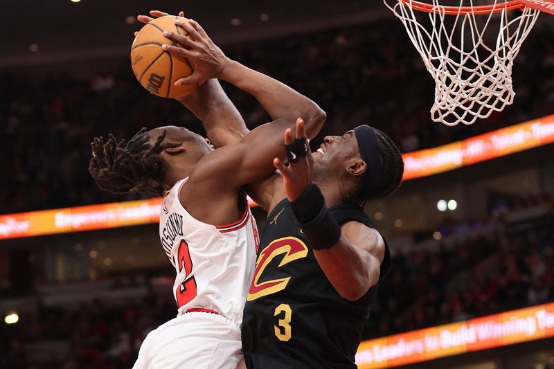 CHICAGO, ILLINOIS - FEBRUARY 28: Caris LeVert #3 of the Cleveland Cavaliers blocks a shot by Ayo Dosunmu #12 of the Chicago Bulls during the second half at the United Center on February 28, 2024 in Chicago, Illinois. NOTE TO USER: User expressly acknowledges and agrees that, by downloading and or using this photograph, User is consenting to the terms and conditions of the Getty Images License Agreement. (Photo by Michael Reaves/Getty Images)