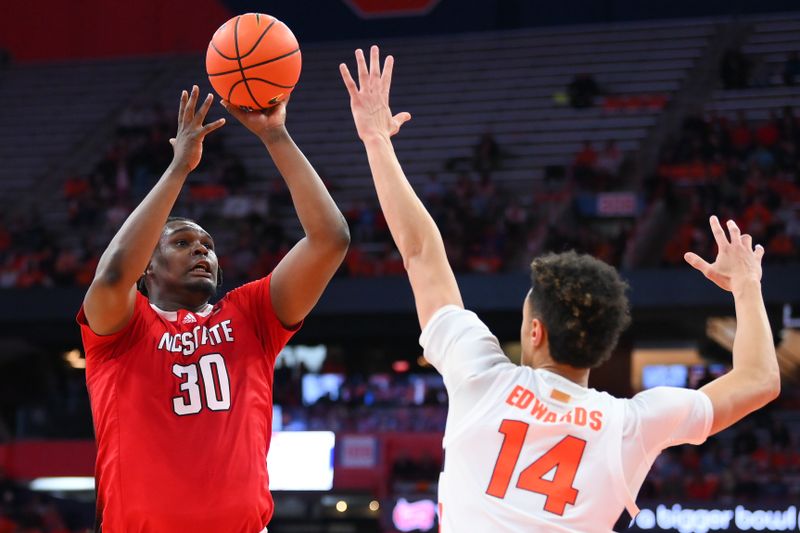 Feb 14, 2023; Syracuse, New York, USA; North Carolina State Wolfpack forward D.J. Burns Jr. (30) shoots the ball against the defense of Syracuse Orange center Jesse Edwards (14) during the second half at the JMA Wireless Dome. Mandatory Credit: Rich Barnes-USA TODAY Sports