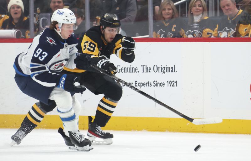 Mar 21, 2026; Pittsburgh, Pennsylvania, USA;  Winnipeg Jets center Brad Lambert (93) and Pittsburgh Penguins right wing Egor Chinakhov (59) chase the puck during the first period at PPG Paints Arena. Mandatory Credit: Charles LeClaire-Imagn Images