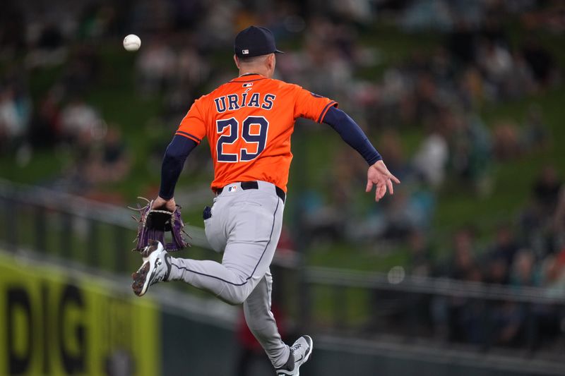 Sep 24, 2025; West Sacramento, California, USA; Houston Astros third baseman Ramon Urias (29) loses control of the ball while attempting to throw to first against the Athletics in the first inning at Sutter Health Park. Mandatory Credit: Cary Edmondson-Imagn Images