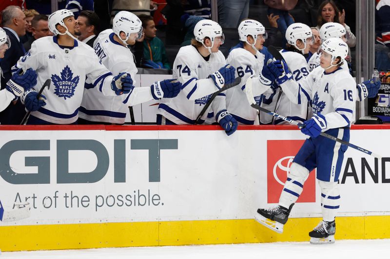 Nov 13, 2024; Washington, District of Columbia, USA; Toronto Maple Leafs right wing Mitch Marner (16) celebrates with teammates after scoring the game tying goal against the Washington Capitals in the final minute of the third period at Capital One Arena. Mandatory Credit: Geoff Burke-Imagn Images