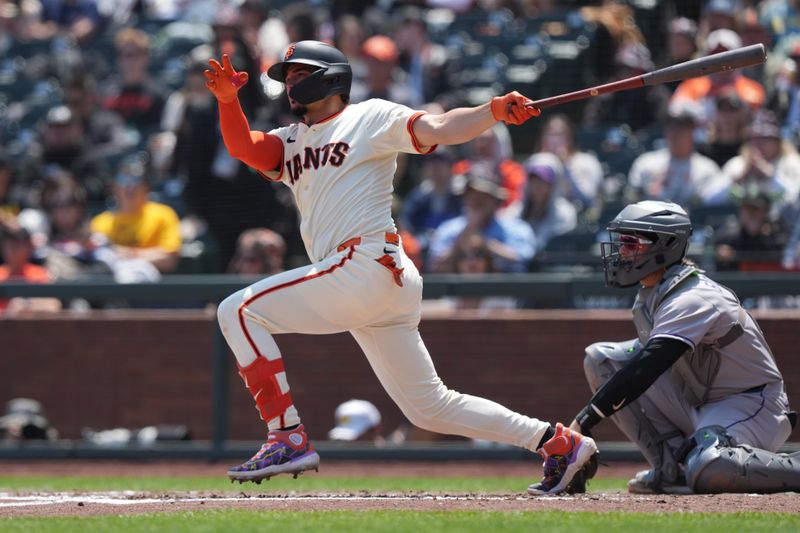 May 3, 2025; San Francisco, California, USA; San Francisco Giants shortstop Willy Adames (2) hits a single against the Colorado Rockies during the fourth inning at Oracle Park. Mandatory Credit: Darren Yamashita-Imagn Images