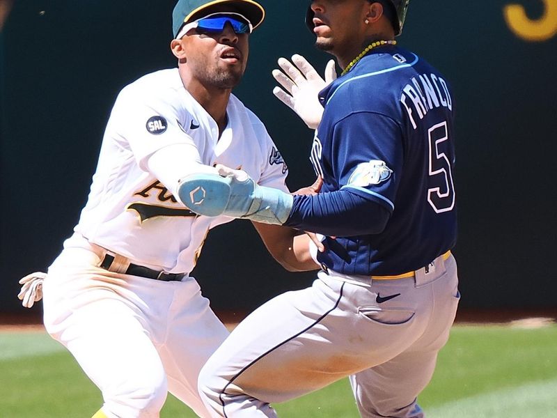 Jun 15, 2023; Oakland, California, USA; Oakland Athletics second baseman Tony Kemp (5) catches Tampa Bay Rays shortstop Wander Franco (5) trying to steal second base during the ninth inning at Oakland-Alameda County Coliseum. Mandatory Credit: Kelley L Cox-USA TODAY Sports