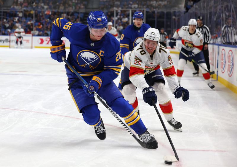 Oct 28, 2024; Buffalo, New York, USA;  Buffalo Sabres defenseman Rasmus Dahlin (26) and Florida Panthers center Jesper Boqvist (70) go after a loose puck during the third period at KeyBank Center. Mandatory Credit: Timothy T. Ludwig-Imagn Images