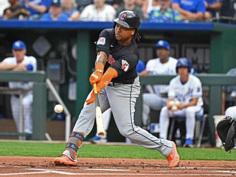 Jun 27, 2024; Kansas City, Missouri, USA; Cleveland Guardians third baseman Jose Ramirez (11) singles in the first inning against the Kansas City Royals at Kauffman Stadium. Mandatory Credit: Peter Aiken-USA TODAY Sports