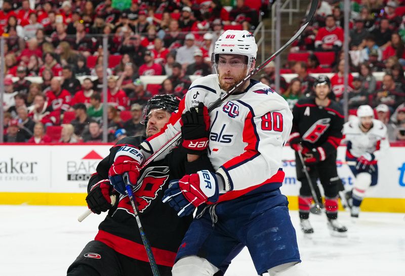 May 10, 2025; Raleigh, North Carolina, USA; Carolina Hurricanes center Sebastian Aho (20) and Washington Capitals left wing Pierre-Luc Dubois (80) battle for position during the second period in game three of the second round of the 2025 Stanley Cup Playoffs at Lenovo Center. Mandatory Credit: James Guillory-Imagn Images